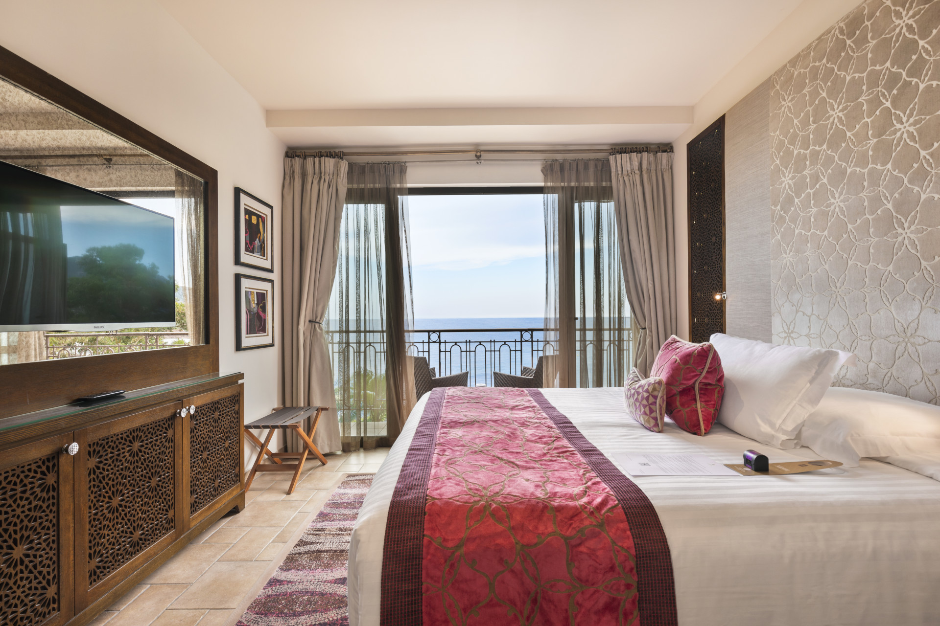 Chambre Double Premium élégamment décorée avec accès terrasse vue mer en arrière-plan – Tiara Miramar Beach Resort